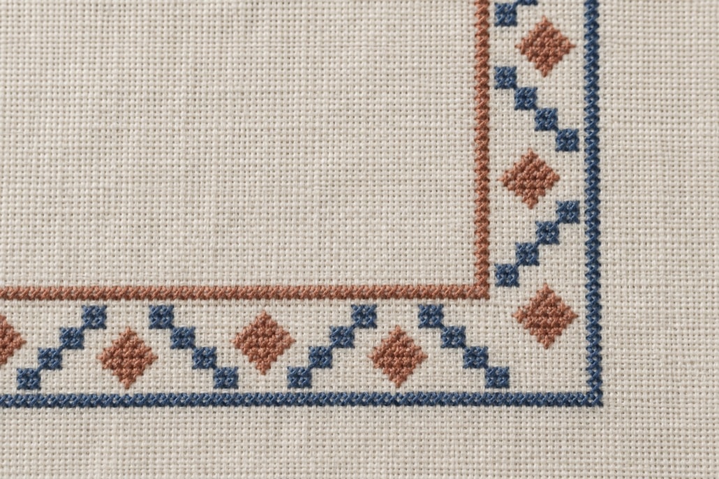 Original geometric counted-stitch border turning a square corner